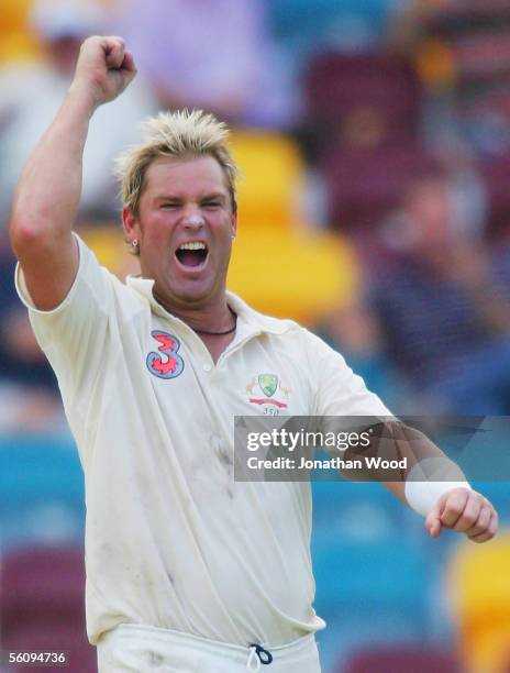 Shane Warne of Australia celebrates his fifth wicket of the innings during day three of the 1st Test between Australia and the West Indies at the...