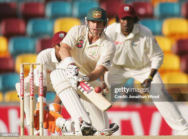 Matthew Hayden of Australia sweeps during day three of the 1st Test between Australia and the West Indies at the Gabba on November 5, 2005 in...