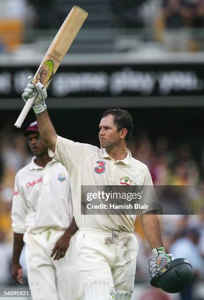 Ricky Ponting of Australia celebrates his century as West Indies captain Shivnarine Chanderpaul looks on during day three of the First Test between...