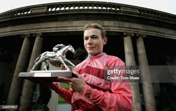 Champion Jockey Jamie Spencer poses with the trophy during the Doncaster Race meet at Doncaster Racecourse on November 5, 2005 in Doncaster, England.