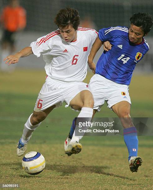 Quan Lei of China , fights for a ball with Eto Yu of Japan, during the football semi-final at the 4th East Asian Games on November 5, 2005 in Macau,...