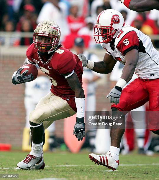 Cornerback A.J. Davis of the North Carolina State Wolfpack grabs the jersey of wide receiver Chris Davis of the Florida State Seminoles at Doak...