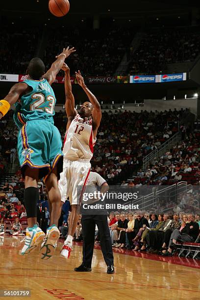 Rafer Alston of the Houston Rockets shoots over J.R. Smith of the New Orleans/Oklahoma City Hornets on November 5, 2005 at the Toyota Center in...