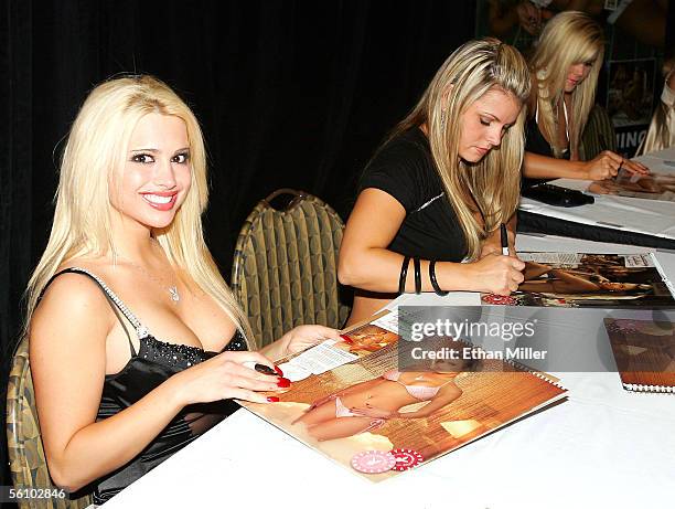 Playboy Playmate Destiny Davis looks up from signing her photo in Playboy's 2006 "Playmates in Las Vegas" calendar during the fourth anniversary...