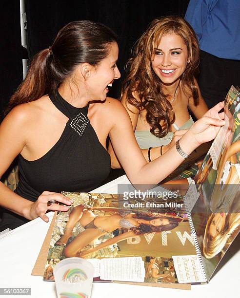 Playboy Playmates Pennelope Jimenez and Jennifer Walcott share a laugh during a signing for Playboy's 2006 "Playmates in Las Vegas" calendar at the...