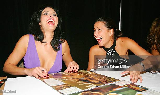 Playboy Playmate of the Year 2005 Tiffany Fallon and Playmate Pennelope Jimenez share a laugh as they sign their photos in Playboy's 2006 "Playmates...