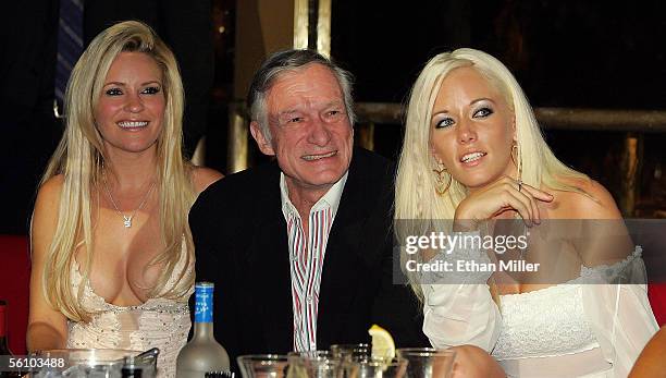 Playboy founder and Editor-in-Chief Hugh Hefner and two of his girlfriends, Bridget Marquardt and Kendra Wilkinson , watch a fashion show to...