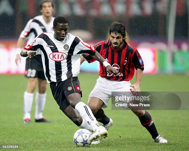 Sulley Ali Muntari of Udinese is pursued by Milan's Gennaro Gattuso during the Serie A match between AC Milan and Udinese at the Giuseppe Meazza, San...