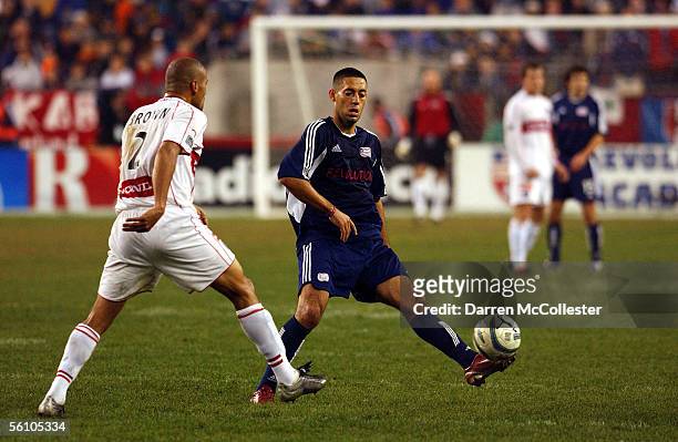 New England Revolution midfielder Clint Dempsey kicks the ball past Chicago Fire defender C. J. Brown during the Eastern Conference Championships at...