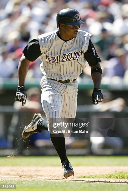 Tony Womack of the Arizona Diamondbacks runs for a single against the Colorado Rockies in the fifth inning at Coors Field in Denver, Colorado. Womack...