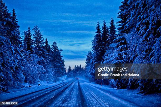 empty snow covered highway at dusk, hemavan, sweden - hemavan stock pictures, royalty-free photos & images