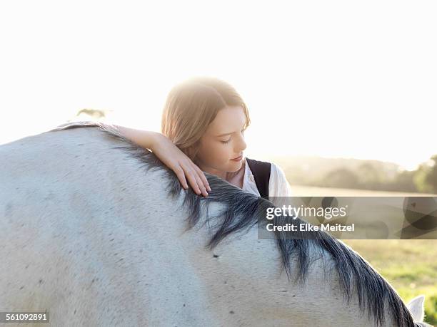 portrait of teenage girl with grey horse - grautier pferdeartige stock-fotos und bilder