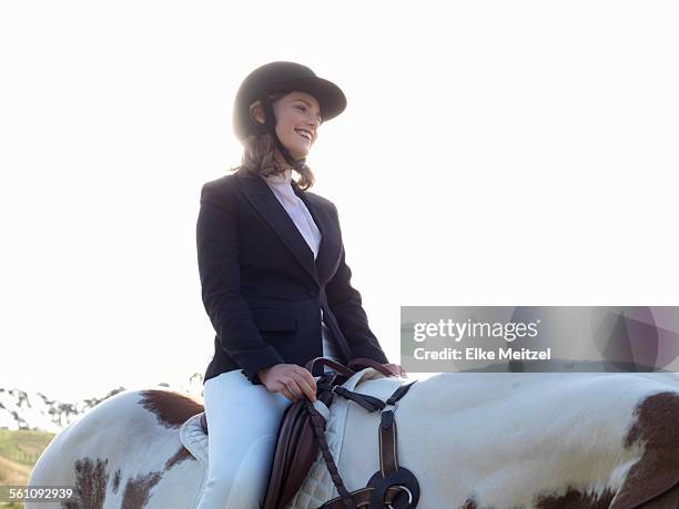 teenage girl riding horse - riding helmet stock pictures, royalty-free photos & images