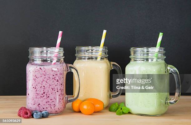still life of three fresh smoothies and fruit - smoothie stockfoto's en -beelden