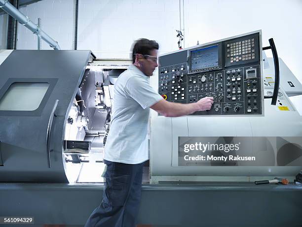 engineer operating cnc lathe in factory - pannello di controllo foto e immagini stock