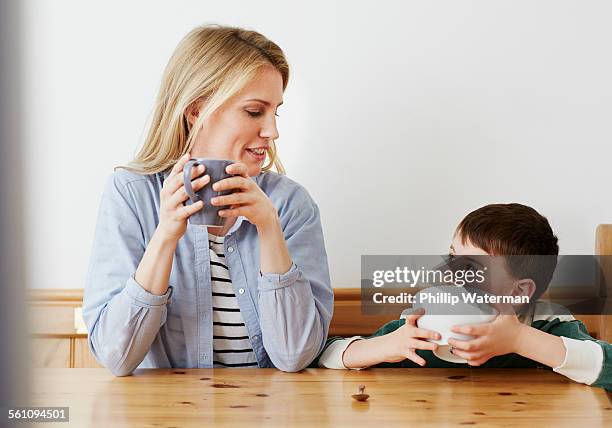 mother and son having breakfast - boy eating cereal foto e immagini stock