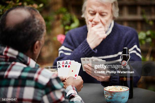 two senior men playing cards - senior men playing cards stock pictures, royalty-free photos & images