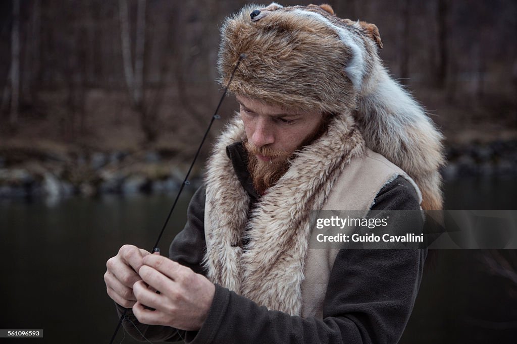 Mid adult man holding fishing line