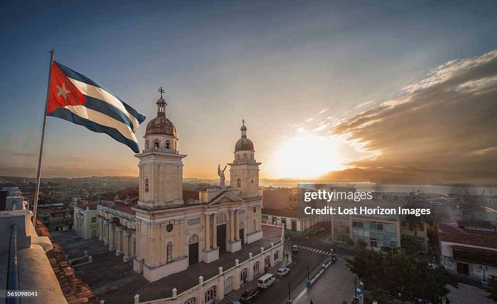 Cuban flag over Plaza de la Cathedral at sunset, Santiago de Cuba, Cuba