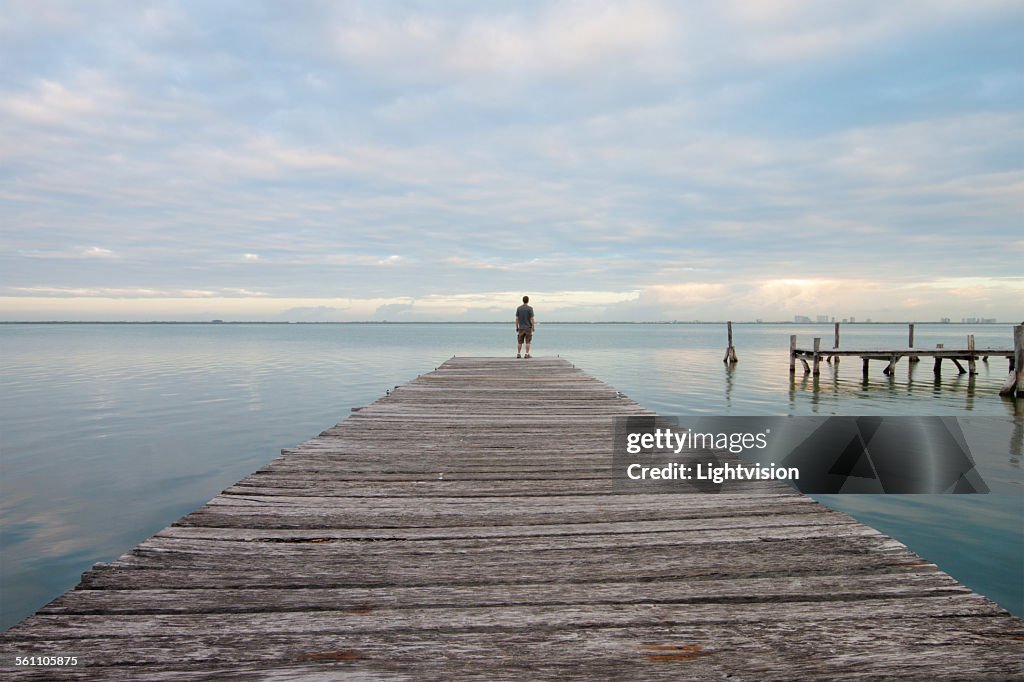 Man Standing on a Pier
