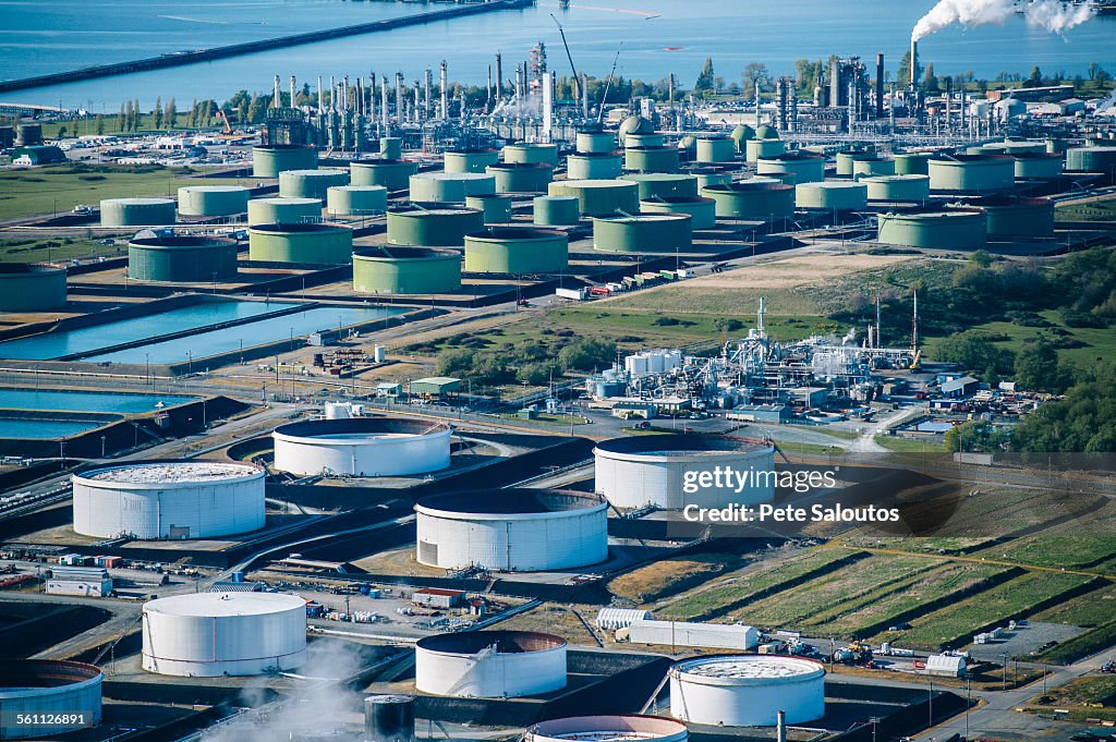 High angle view of oil storage tanks in coastal oil refinery