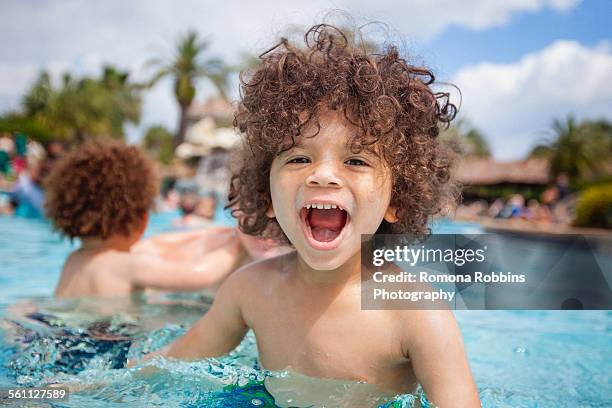 cute boy playing in swimming pool with brother, destin, florida, usa - destin stock pictures, royalty-free photos & images