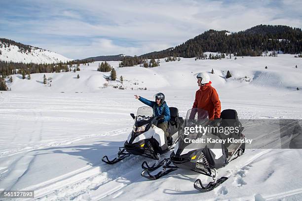 friends on snowmobile, jackson hole, wyoming - snowmobile stock pictures, royalty-free photos & images