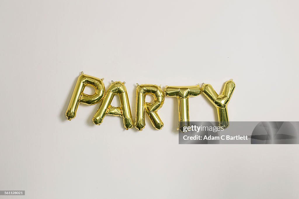 Word party in gold inflatable capital letters