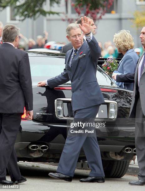 Prince Charles, Prince of Wales, waves to the crowd as he and his wife Camilla, Duchess of Cornwall, leave Martin Luther King Middle School November...