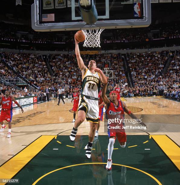 Vladimir Radmanovic of the Seattle Sonics takes the ball to the basket past James Singleton of the Los Angeles Clippers during a game at the KeyArena...