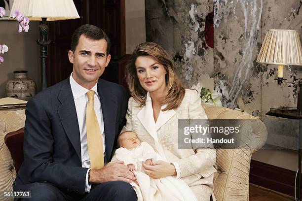 In this handout picture from the Casa Real, Prince Felipe of Spain and Princess Letizia hold their newborn daughter Princess Leonor for a photo...