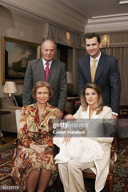 In this handout picture from the Casa Real, Princess Letizia holds her newborn daughter Princess Leonor with her husband Prince Felipe and his...