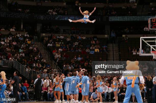 Cheerleaders from the Denver Nuggets perform a stunt during a stop in play against the Milwaukee Bucks during a preseason game October 26, 2005 at...