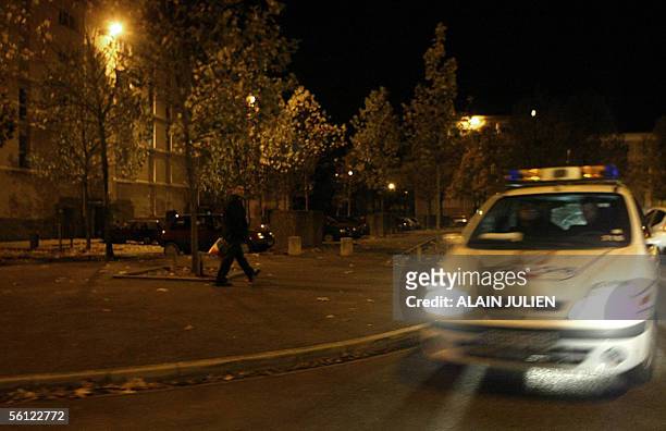 Police car patrols a deserted street of a northern suburb of Amiens, 09 November 2005 after authorities declared a curfew from 10pm to 6am following...