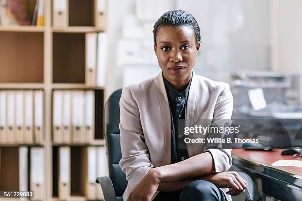 portrait of young black fashion designer in office - serious woman stock-fotos und bilder