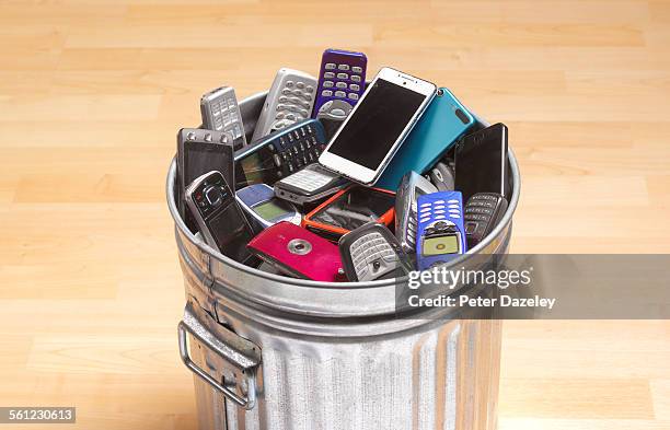 phones and smart phones in dustbin - broken smartphone fotografías e imágenes de stock