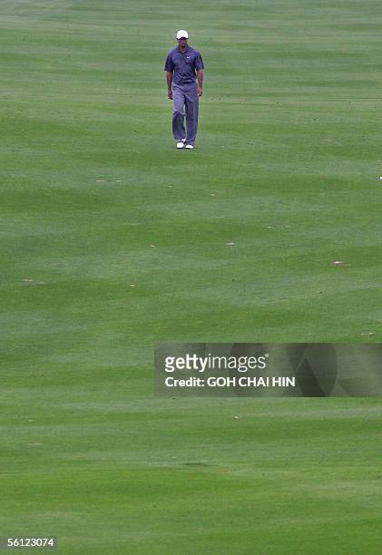World number one Tiger Woods walks down the fairway all by himself during a practice round at the five-million-dollar HSBC Champions tournament in...