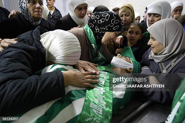 Palestinian women mourn 20 November 20005 over the body of fifteen-year-old Mohammed Abu Salha who was killed yesterday as he and at least two other...