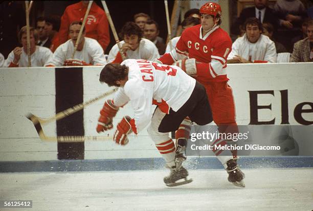 Valeri Kharlamov of the Soviet Union checks Ron Ellis of Canada during the 1972 Summit Series in September, 1972 at the Luzhniki Ice Palace in...