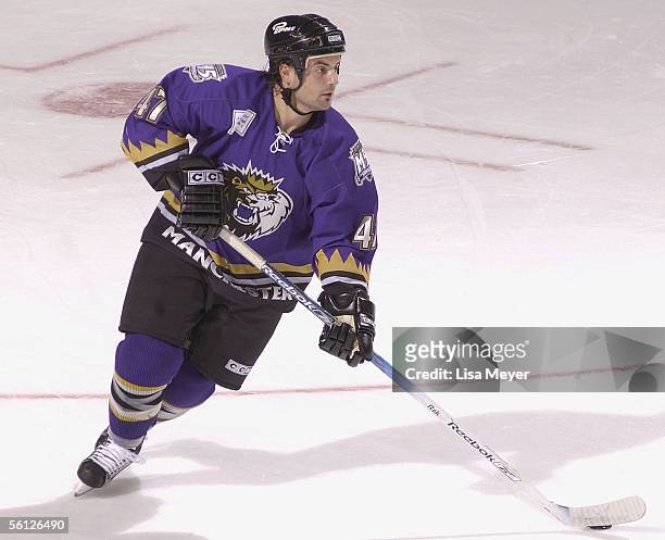 Mark Ardelan of the Manchester Monarchs skates with the puck against the Bridgeport Sound Tigers at the Arena at Harbor Yard on November 4, 2005 in...