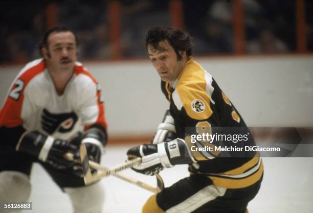 Canadian professional hockey player Johnny Bucyk of the Boston Bruins skates on the ice during an away game against the Philadelphia Flyers, The...