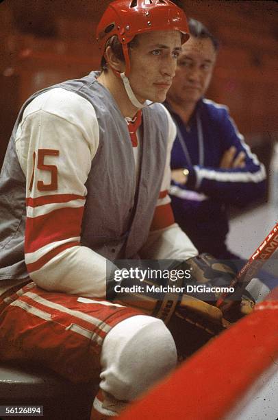 Alexander Yakushev of the Soviet Union sits on the bench next to assistant coach Boris Kulagin during practice between games in the 1972 Summit...