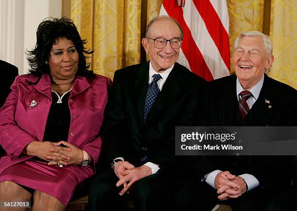 Outgoing Federal Reserve Board Chairman Alan Greenspan smiles during the reading of his bio while seated next to singer Aretha Franklin and actor...