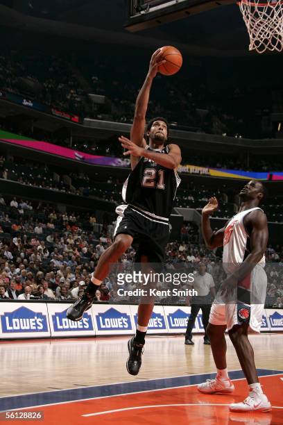 Tim Duncan of the San Antonio Spurs gets away from Emeka Okafor of the Charlotte Bobcats and heads for the net on November 9, 2005 at the Charlotte...