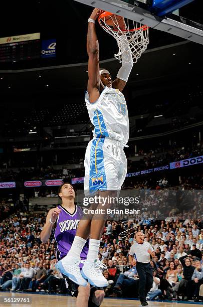 Carmelo Anthony of the Denver Nuggets dunks the ball against Kevin Martin of the Sacramento Kings in the first quarter on November 9, 2005 at the...