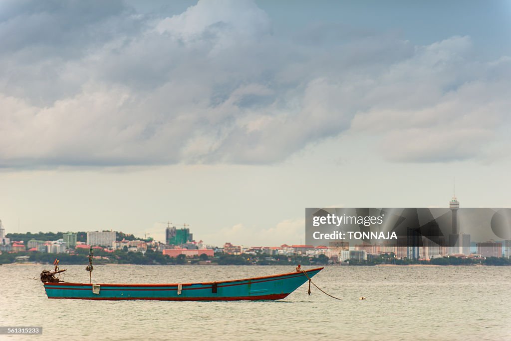 Thai traditional fishing boat and Pattaya city