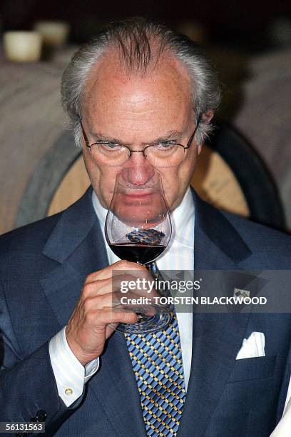 King Carl XVI Gustaf of Sweden smells the bouquet of Yalumba's premium Octavius wine in the Barossa Valley north of Adelaide, 10 November 2005....