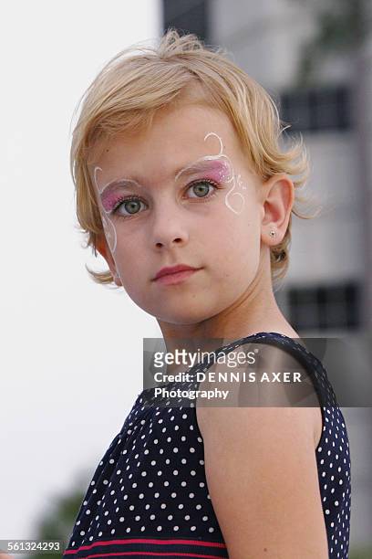face painted young girl looking - n n girl models imagens e fotografias de stock
