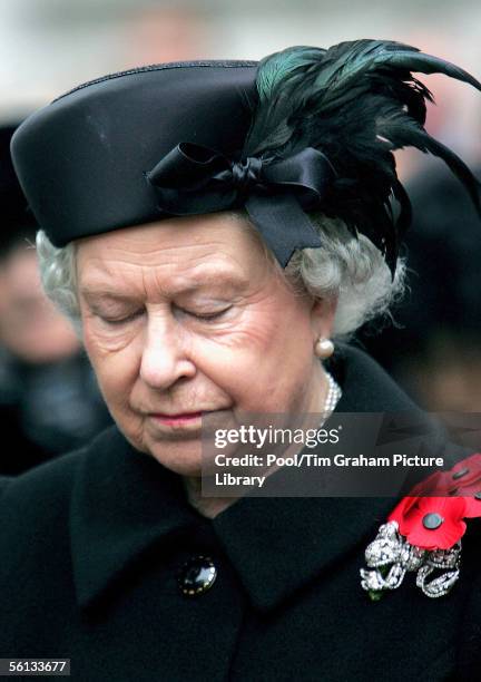 Queen Elizabeth II observes a minute's silence for those that died fighting for Britain and its allies in conflict as she visits the Field of...