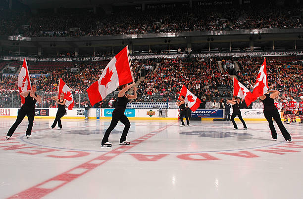 Skaters carry Canadien flags during introductions to the Hockey Hall of Fame Legends of Hockey Game between the Canada Legends Team and the Russia...